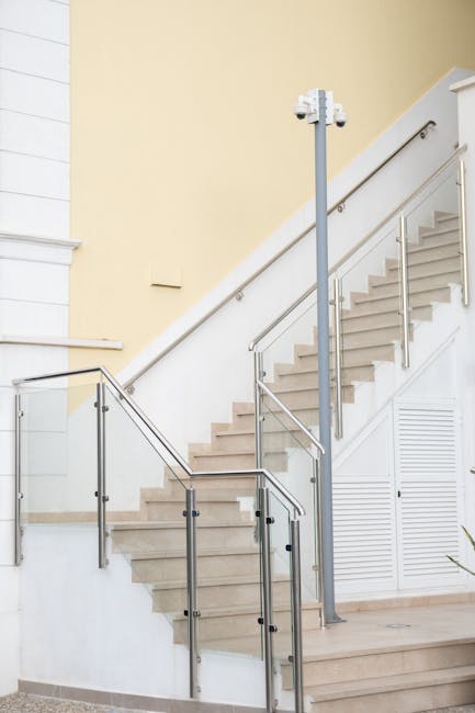 A stylish interior staircase with glass railings in a modern building.