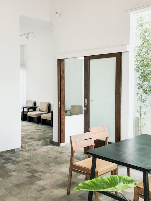 Bright, minimalist dining room with natural lighting and modern furniture.