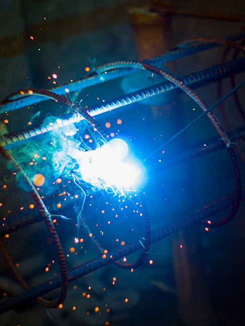 Close-up of intense welding sparks flying from a metal frame, showcasing industrial craftsmanship.