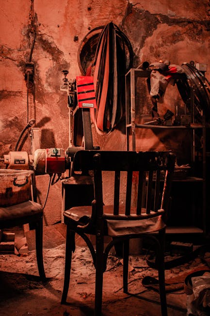 Vintage workshop setting with rustic chair and machinery, invoking industrial nostalgia.