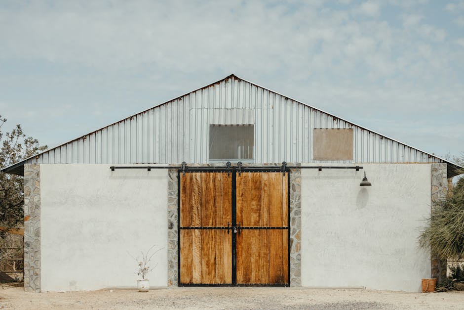 A charming rustic barn with wooden sliding doors, located in rural Mexico's picturesque countryside.