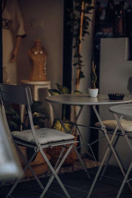 Charming café corner featuring a cactus, metal chairs, and table in a cozy indoor setting.