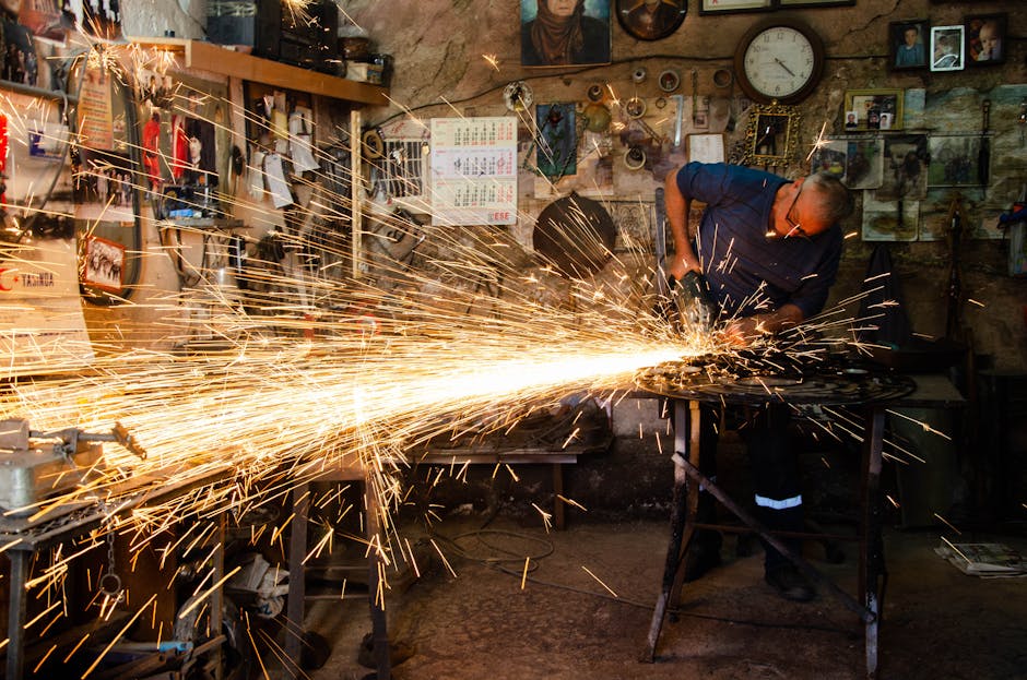 Skilled artisan engaged in welding, creating bright sparks in a workshop in Ankara, Türkiye.