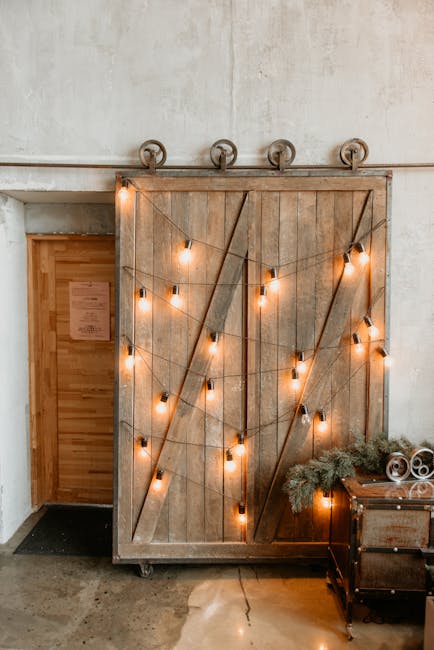 Warm and inviting barn door decor with string lights in a rustic interior setting.