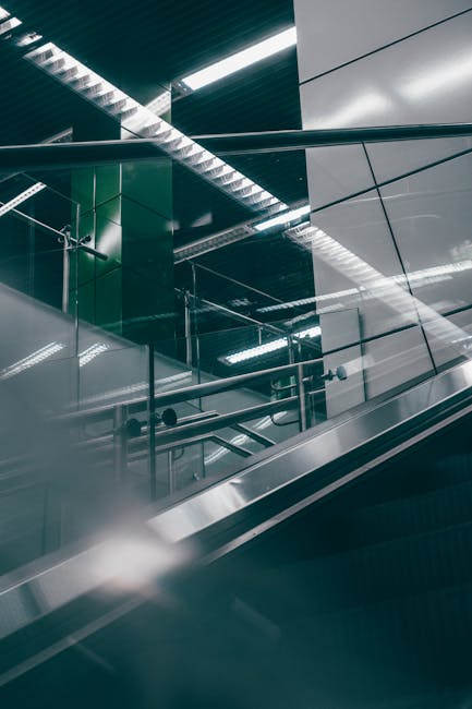 Sleek indoor escalator with glass and metal features in a contemporary setting.