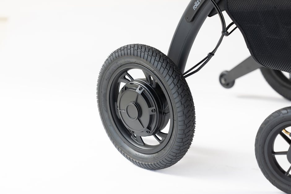 Detailed close-up of a wheel on a modern mobility device against a white background.