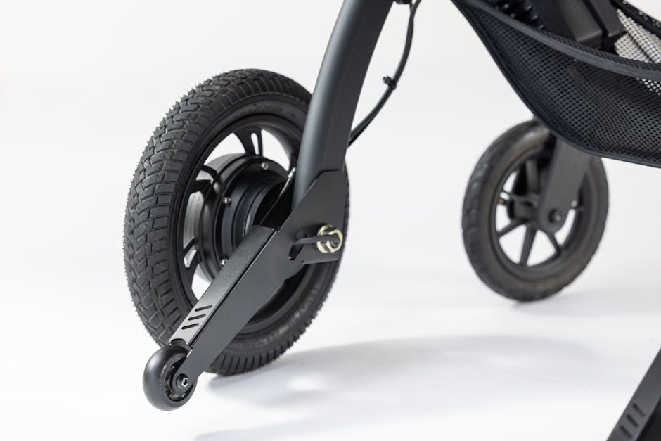 Detailed view of wheelchair wheels, highlighting design features, against a white backdrop.