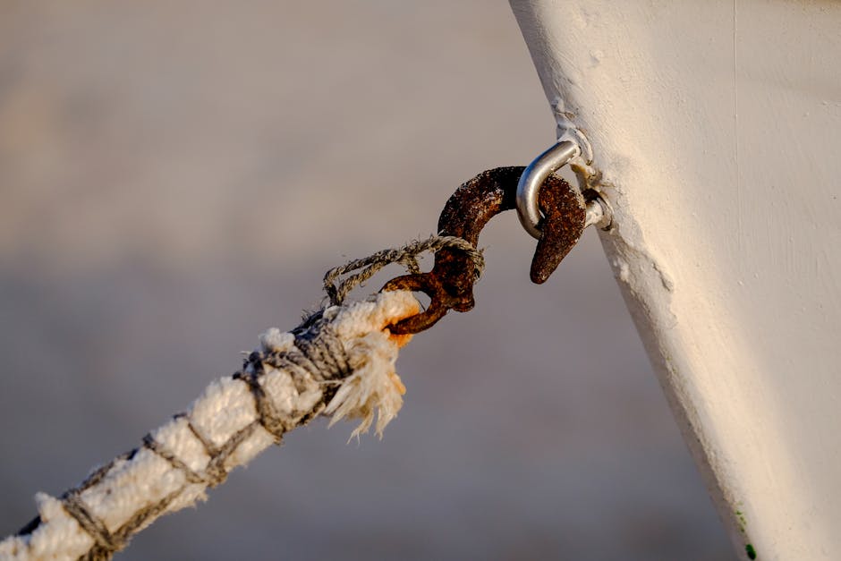 Detailed shot of a rusty boat hook and rope connection, Bolonia beach.