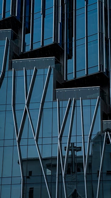 Reflective glass facade of modern building with architectural design elements in Vietnam.