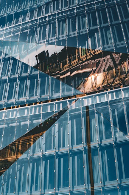 Geometric reflections on a modern glass building facade capturing Berlin architecture.