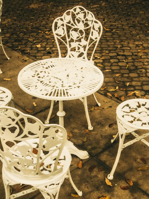 A classic outdoor iron garden furniture set with antique design, perfect for vintage decor.