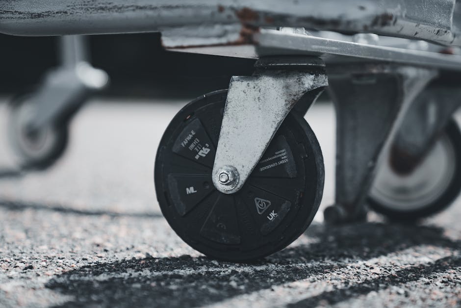 Detailed image of a shopping cart wheel with focus on urban texture.