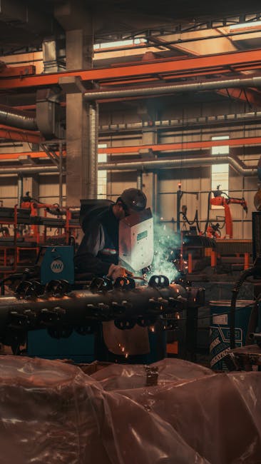 Welder engaged in precision welding work in a Konya factory, showcasing sparks and protective gear.