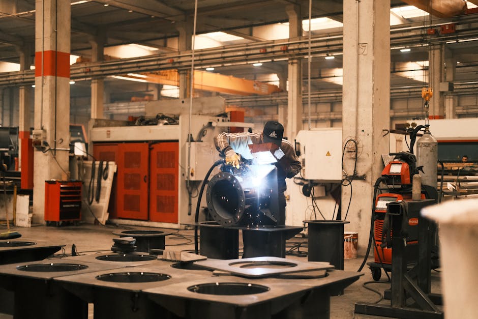 A welder working on metal components in an industrial factory in Konya, Türkiye.