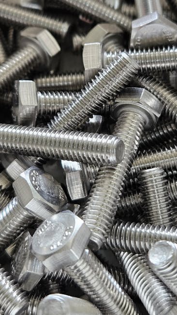 Detailed image of numerous shiny steel hex bolts, ideal for industrial use.
