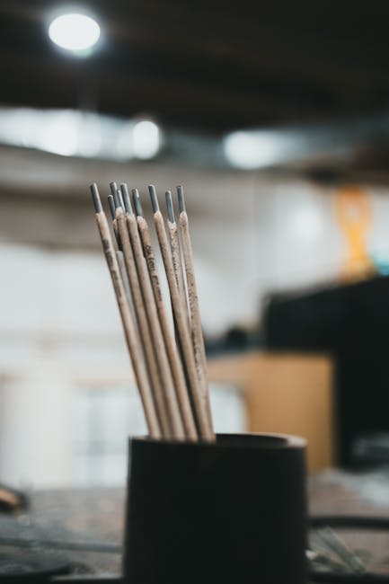 Close-up of welding rods in a workshop, showcasing industrial tools.