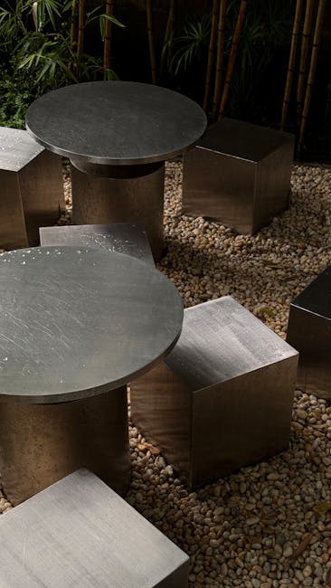 Contemporary metal seating on a pebble patio, surrounded by bamboo in Ho Chi Minh City.