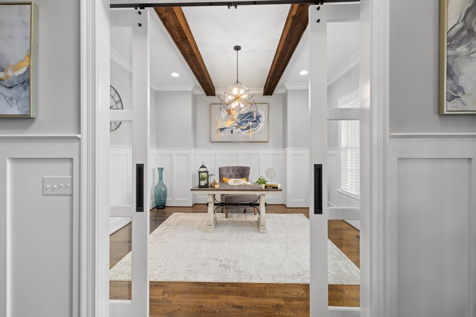 Spacious modern home office featuring elegant decor and contemporary lighting.