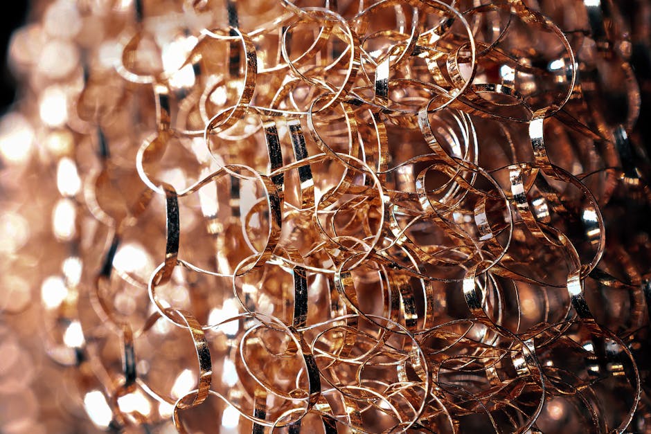 Entangled metal wire with rounded edges and glowing surface on blurred background in twilight