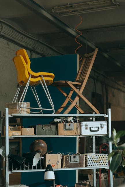 Interior view of a shelf with vintage furniture pieces and storage items.