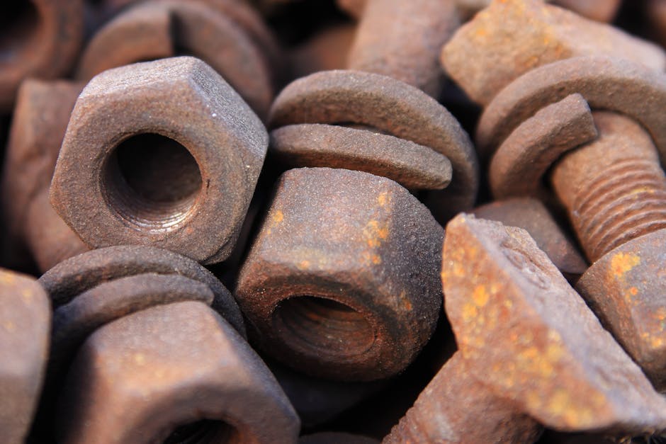 Close-up of a pile of rusty bolts and nuts showing detailed corrosion and texture.