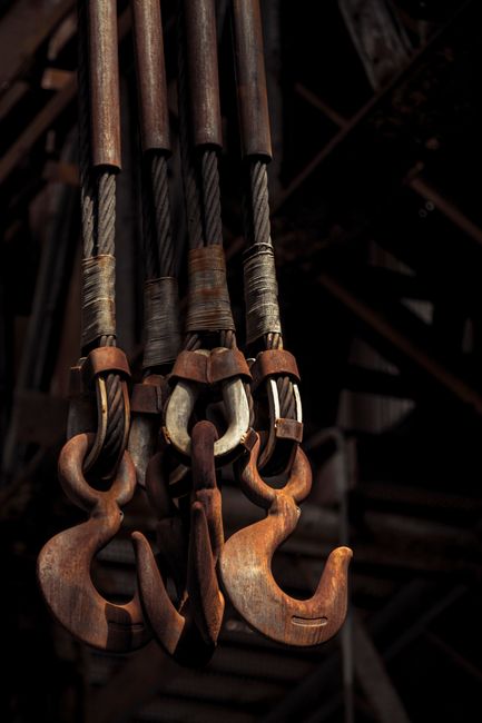 Close-up of rusted industrial hooks in an abandoned Bethlehem Steel site, PA.