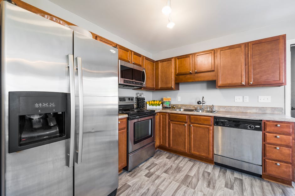 Spacious kitchen with wooden cabinets and stainless steel appliances for a cozy home feel.